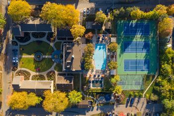 a birds eye view of a tennis court with trees and a pool at Indian Creek Apartments*, Ohio